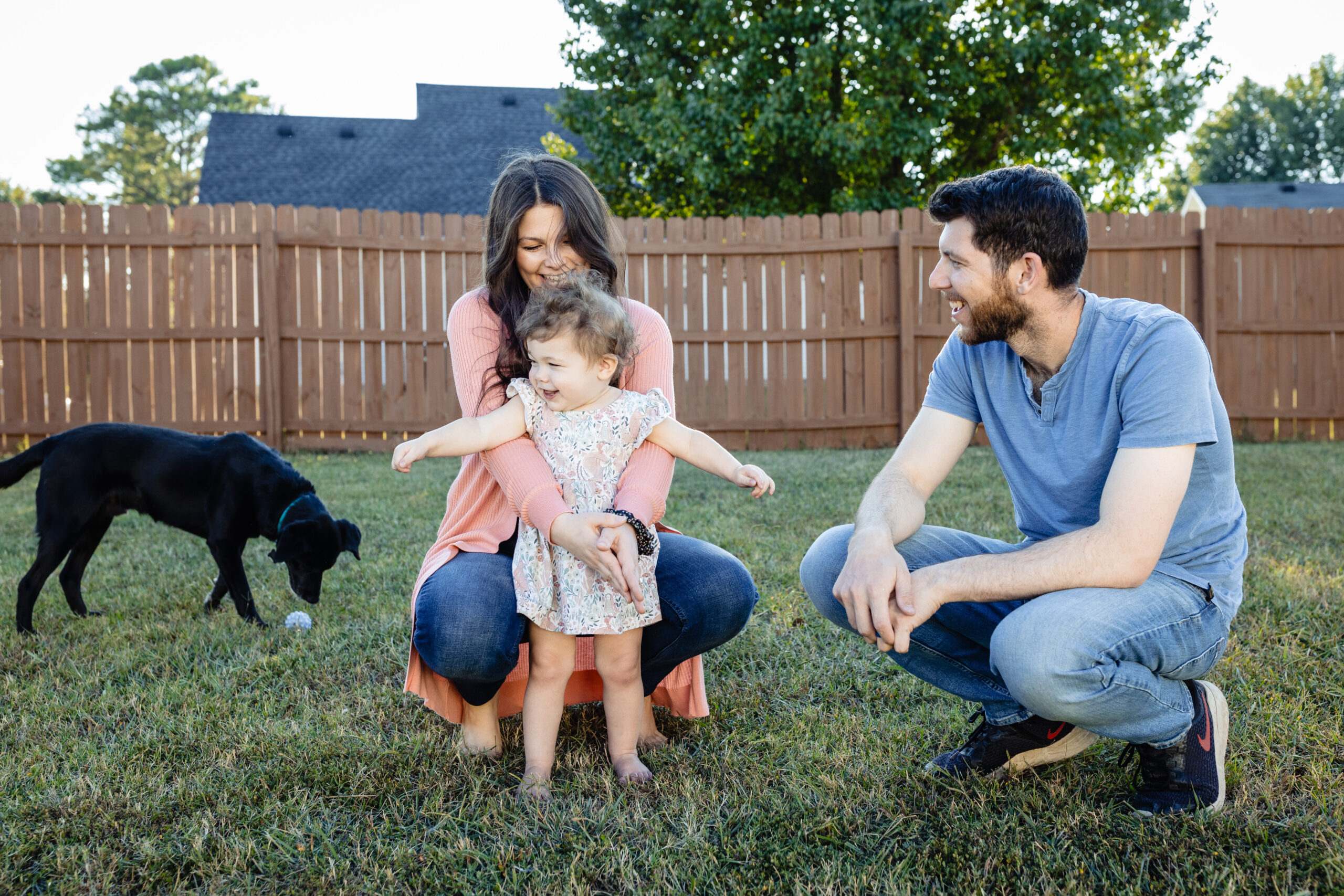 The Cardel Family squat and snuggle in the backyard before their family film.